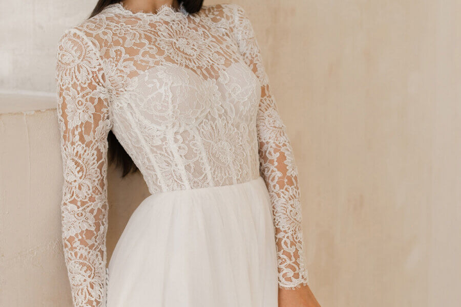 female posing with wedding dress on