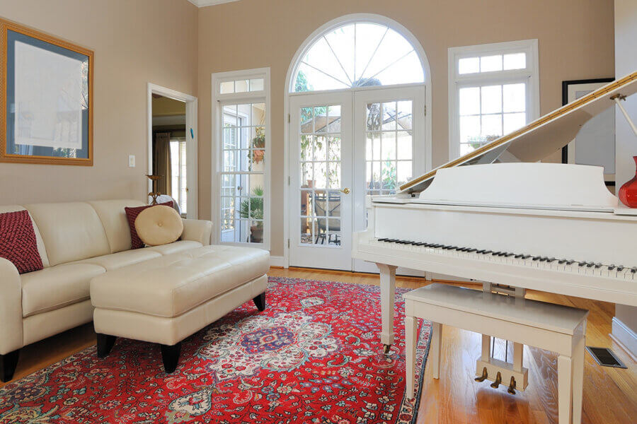 oriental rugs in large living room with piano